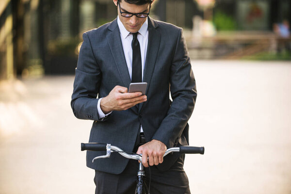 Young handsome man with business suit driving bycicle - Corporate businessman portrait, concepts about business, mobility and lifestyle