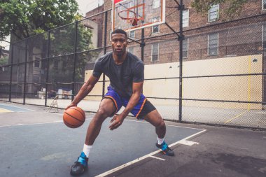 Basketball player training on a court in New york city clipart