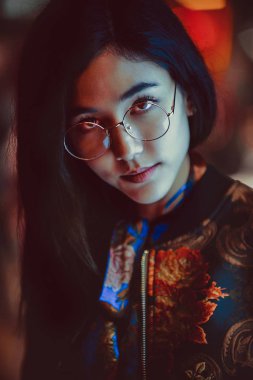 Açık havada, arka plan bulanık neon ışıkları ile poz güzel karışık ırk kadın