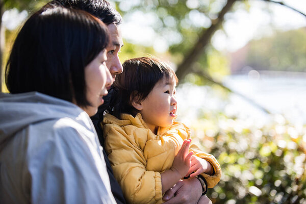 Happy and playful japanese family in a park in Tokyo
