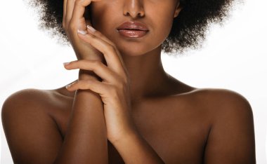 Portrait of pretty afro american woman in a studio for a beauty session - Beautiful girl posing on colored background clipart