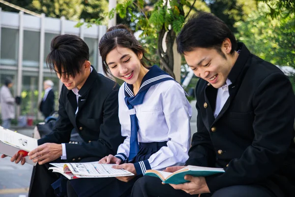 Yung japanese students with school uniform bonding outdoors - Group of asian teenagers having fun