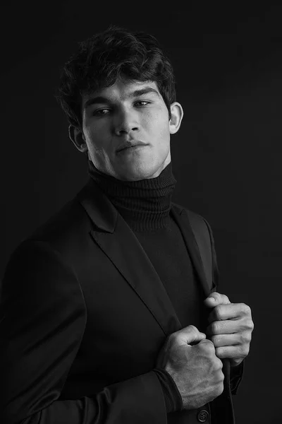 Portrait of young handsome man in a photographic studio