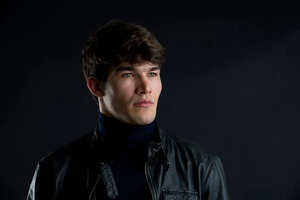 Portrait of young handsome man in a photographic studio