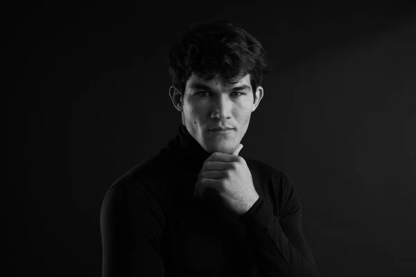 Portrait of young handsome man in a photographic studio