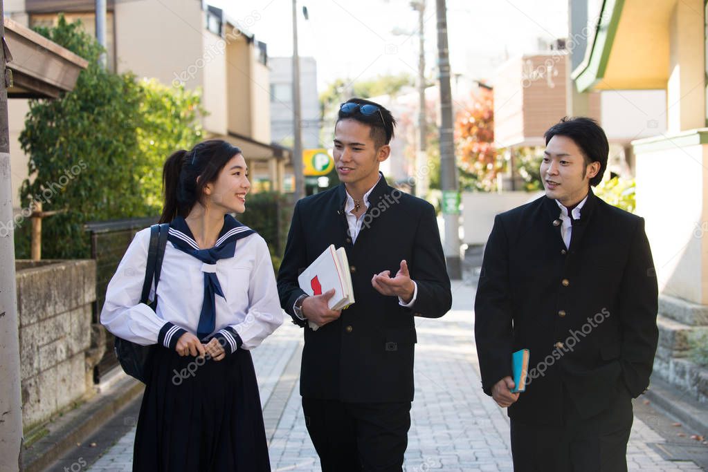 Yung japanese students with school uniform bonding outdoors - Group of asian teenagers having fun