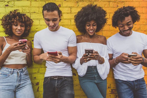 Group of friends spending time togeher in New york city, spending time on mobile phones