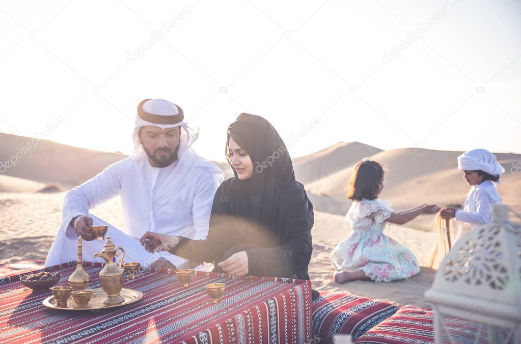 Happy family spending a wonderful day in the desert making a picnic