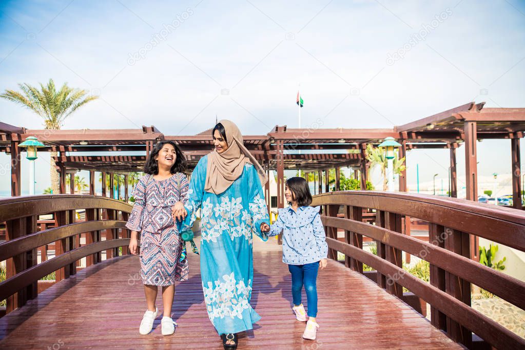 Happy arabian family having fun in Dubai - Mom together with her daughters