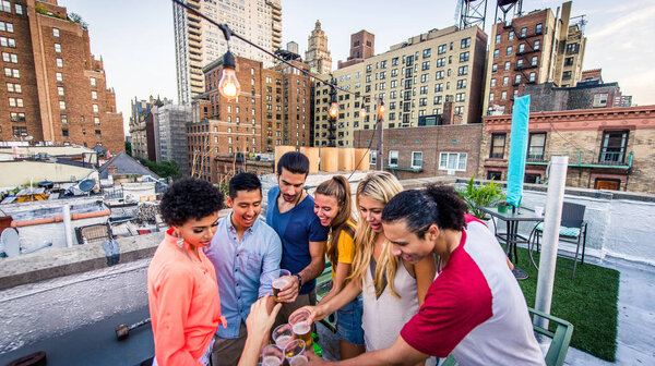 Молодые счастливые люди, ужинающие барбекю на крыше в Нью-Йорке - Группа друзей, весело проводящих время
