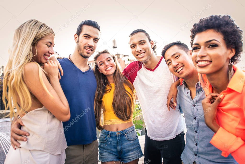 Young happy people having a barbecue dinner on a rooftop in New York - Group of friends having party and having fun