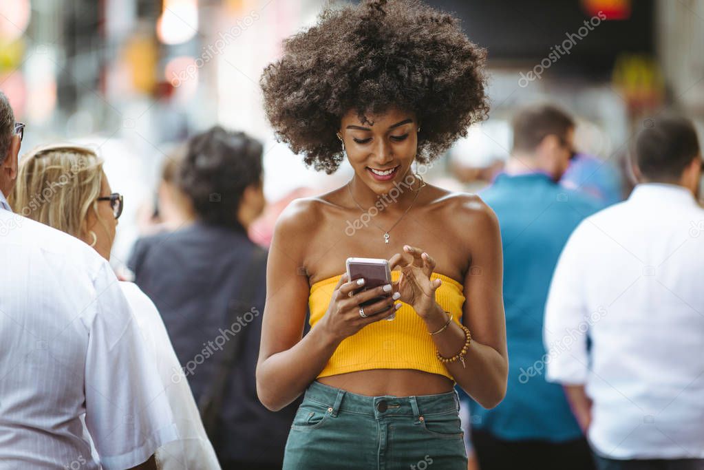 Happy african american woman smiling. Beautiful young female walking and having fun in New York city