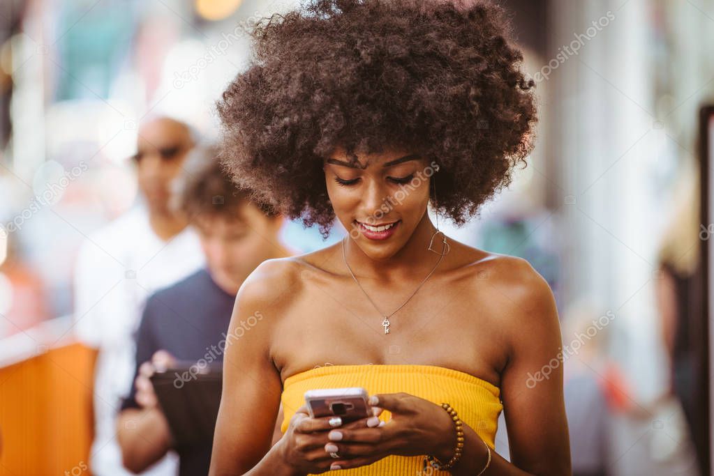 Happy african american woman smiling. Beautiful young female walking and having fun in New York city