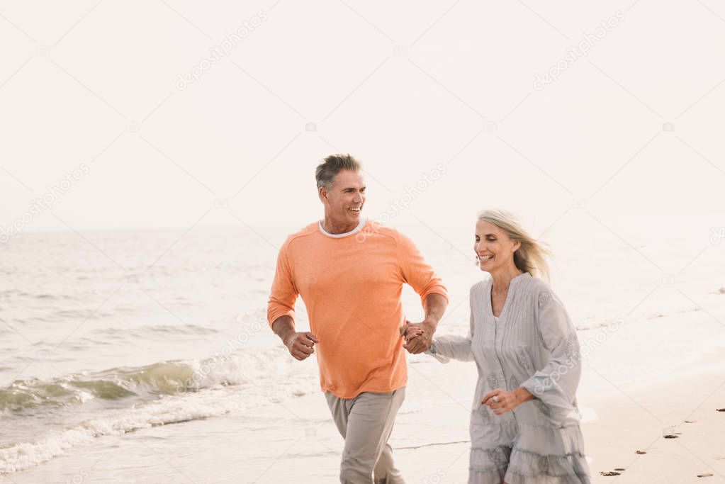 Beautiful happy senior couple dating outdoors - Youthful married couple having fun and enjoying life together