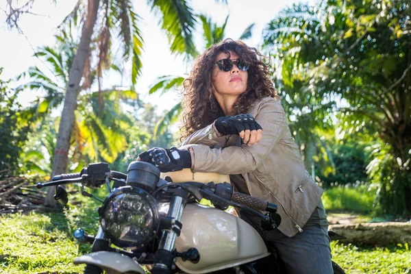 Motociclista mujer conduciendo una moto racer café —  Fotos de Stock