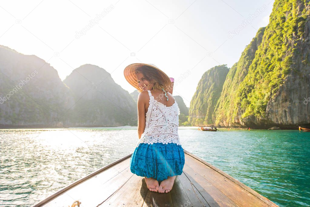 Beautiful woman on a long-tail boat in Thailand