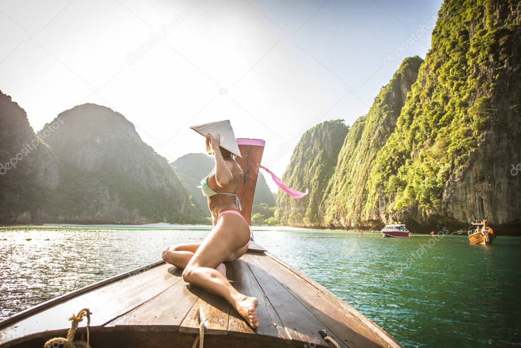 Beautiful woman on a long-tail boat in Thailand
