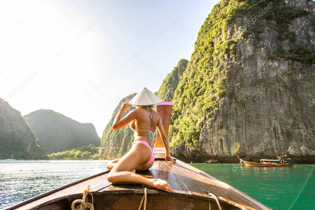 Beautiful woman on a long-tail boat in Thailand