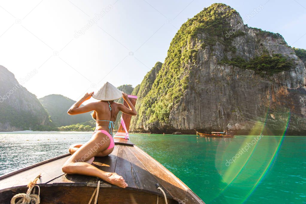 Beautiful woman on a long-tail boat in Thailand