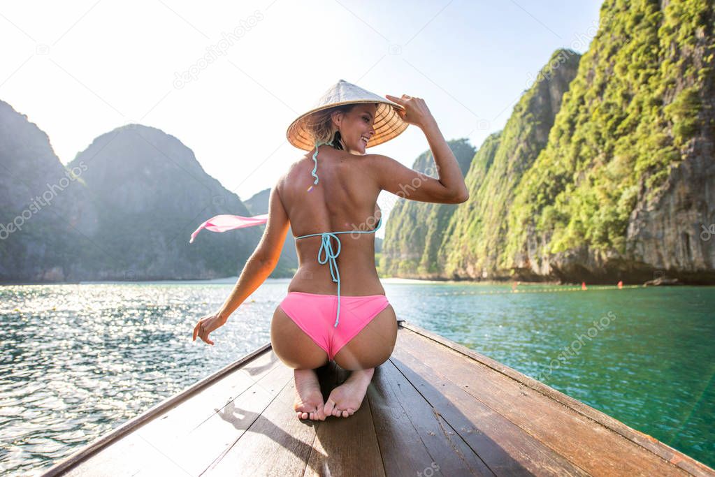 Beautiful woman on a long-tail boat in Thailand