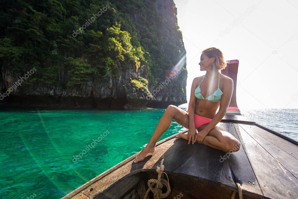 Beautiful woman on a long-tail boat in Thailand