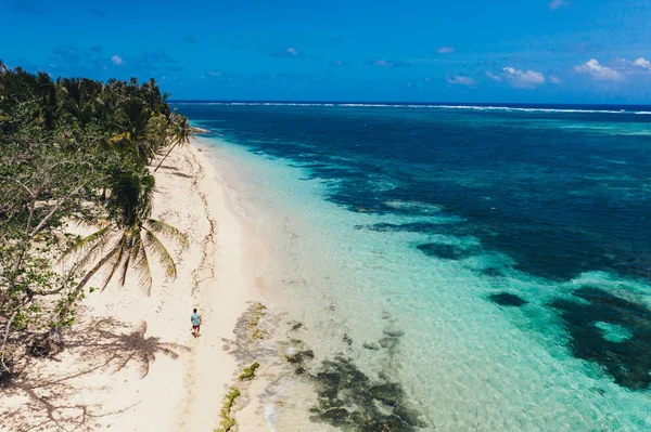 Homme debout sur la plage et profitant de l'endroit tropical avec un — Photo