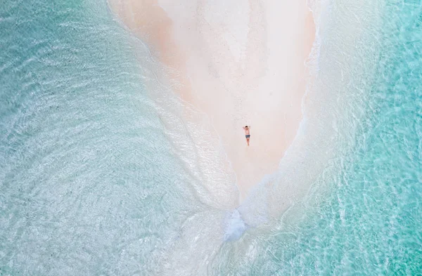 Γυμνή θέα στο νησί από τον ουρανό. Άνθρωπος χαλαρωτικό λήψη ηλιομπανιων σε t — Φωτογραφία Αρχείου