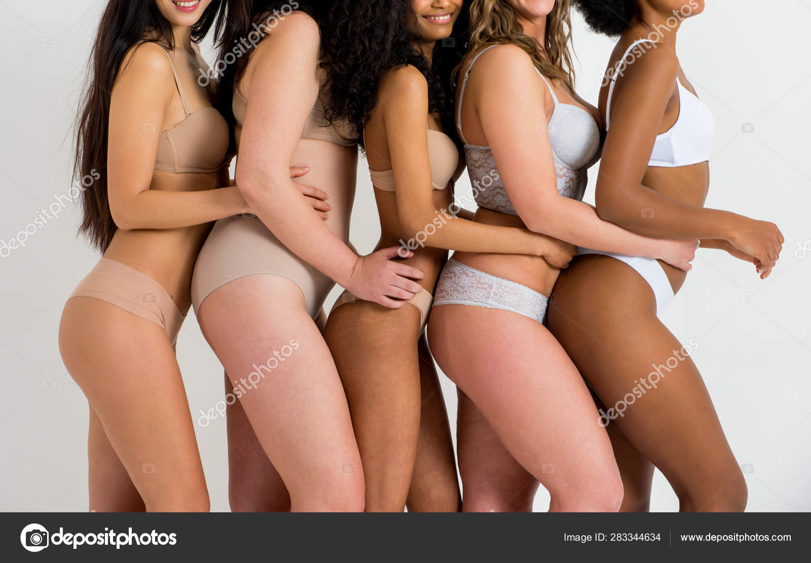 Multi-ethnic group of beautiful women posing in underwear in a