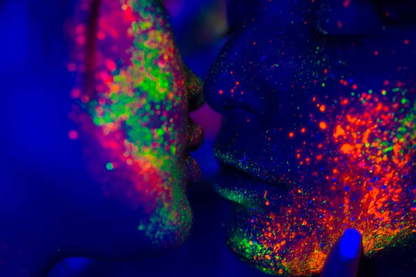 Fashion model with fluo painting on the face