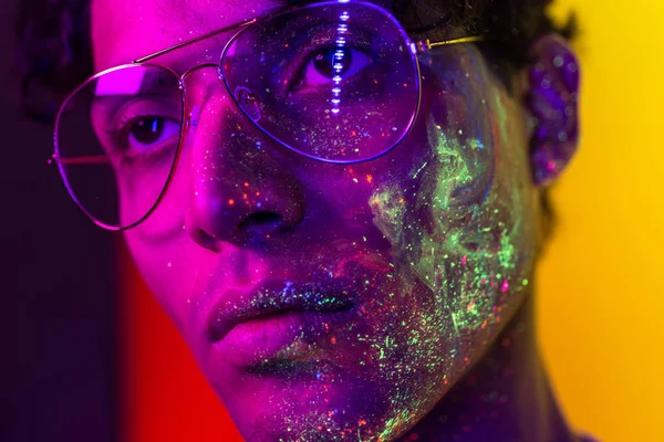 Fashion model with fluo painting on the face — Stock Photo, Image