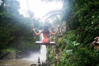 Pretty girl at Tegenungan Waterfall, Bali clipart