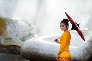 Asyalı bir kız Budist tapınağını ziyaret ediyor.