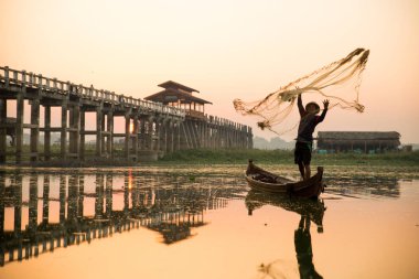 Myanmar balıkçısı göle ağ atıyor. 