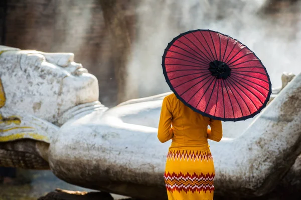 Asyalı bir kız Budist tapınağını ziyaret ediyor.