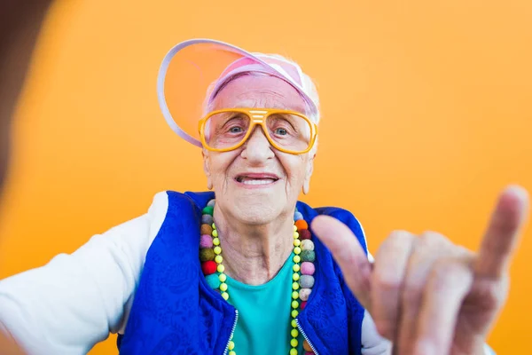 Funny grandmother portraits. 80s style outfit. trapstar taking a — Stock Photo, Image