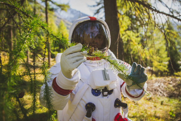 Astronaut exploring a new planet. Searching for a new home for h