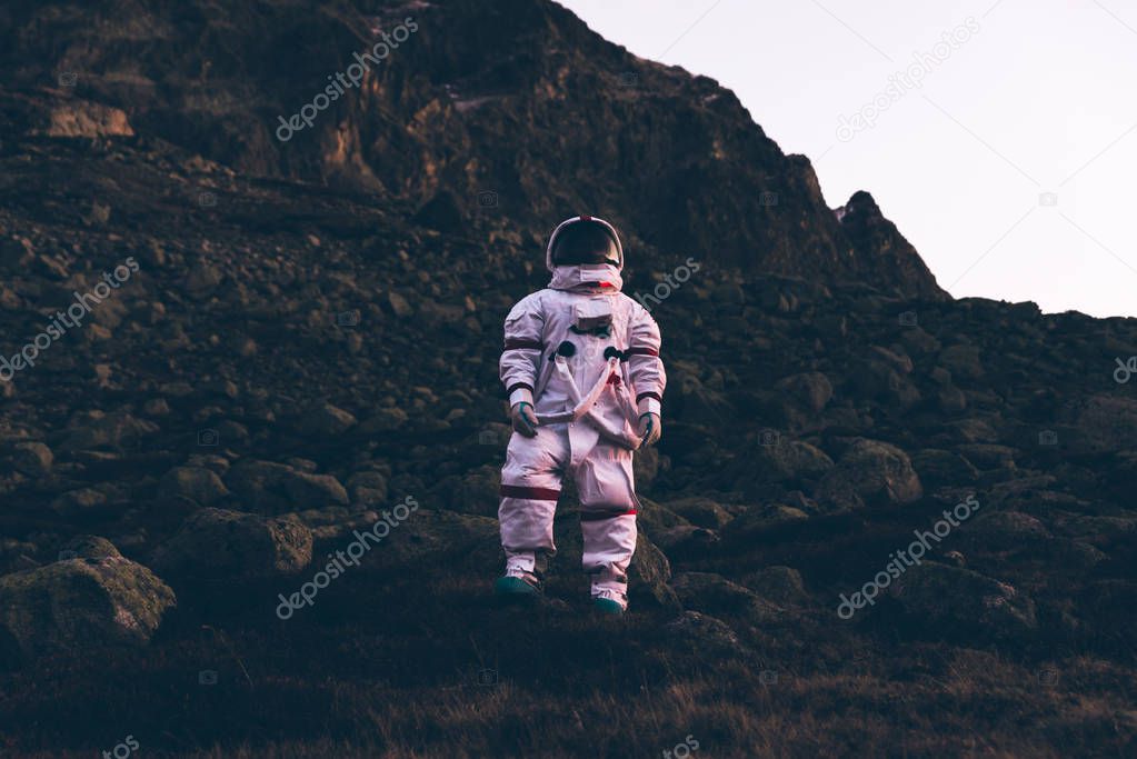 Astronaut exploring a new planet. Searching for a new home for h