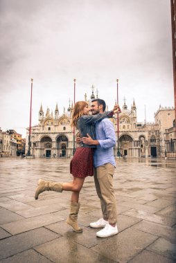 Beatiful young couple having fun while visiting Venice - Tourists travelling in Italy and sightseeing the most relevant landmarks of Venezia - Concepts about lifestyle, travel, tourism clipart