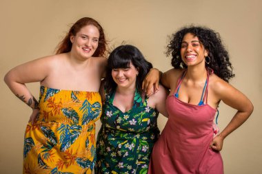 Group of 3 oversize women posing in studio - Beautiful girls accepting body imperfection, beauty shots in studio - Concepts about body acceptance, body positivity and diversity clipart