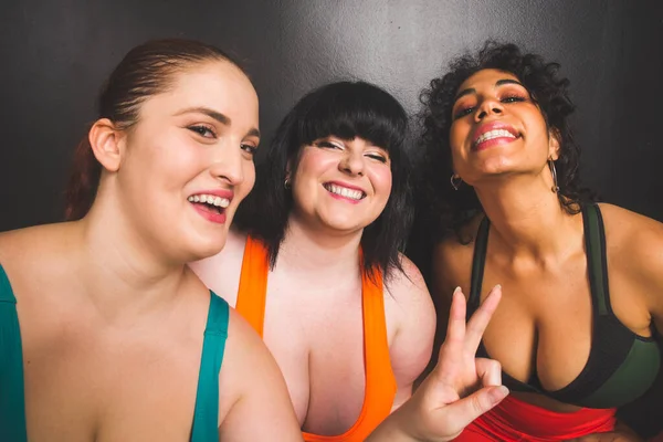 Group of 3 oversize women posing in studio - Beautiful girls accepting body imperfection, beauty shots in studio - Concepts about body acceptance, body positivity and diversity