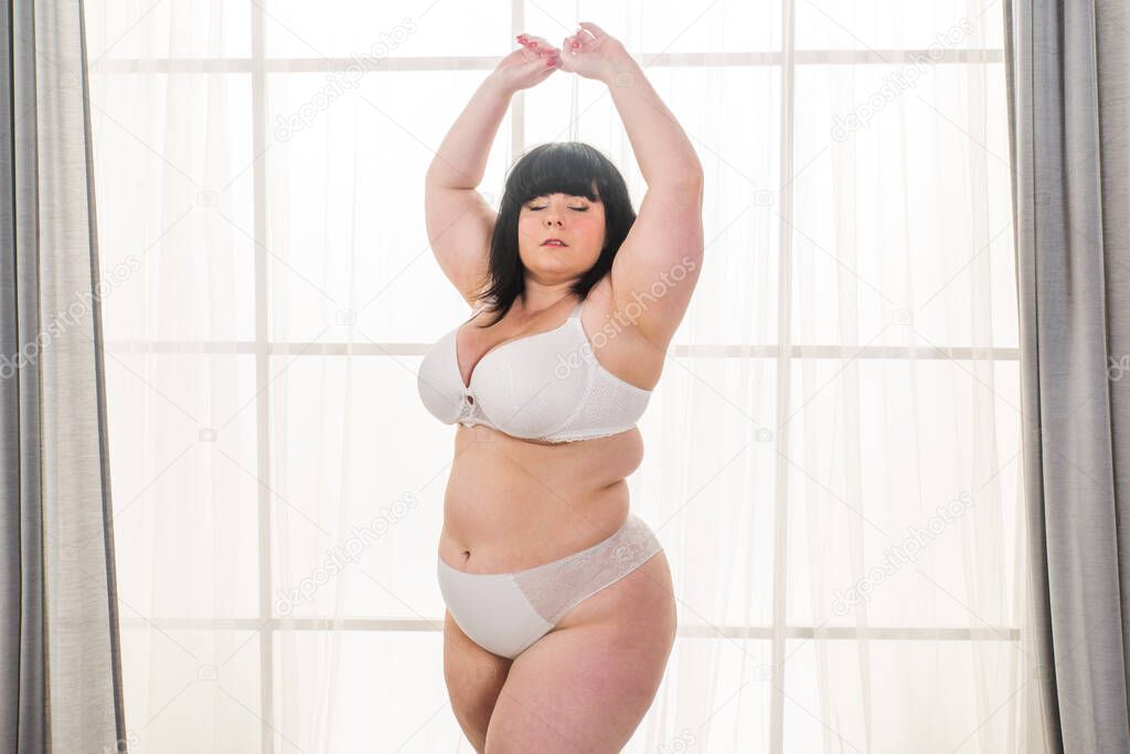 Pretty oversize woman posing in studio - Beautiful girl accepting her body imperfection, beauty shot in studio - Concepts about body acceptance, body positivity and diversity