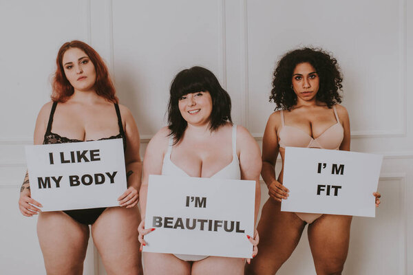 Group of 3 oversize women posing in studio - Beautiful girls accepting body imperfection, beauty shots in studio - Concepts about body acceptance, body positivity and diversity
