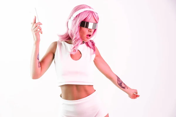 ピンクの髪のダンスと楽しさを持つ若い女性 未来的な衣装とカラーゲル肖像画 — ストック写真