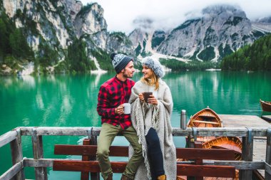 Braies, İtalya 'da bir dağ gölünü ziyaret eden genç ve güzel bir çift - sonbahar yaprakları arasında tatil yapan yürüyüş kıyafetli turistler - seyahat, yaşam tarzı ve seyahat tutkusu kavramları