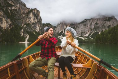 Braies, İtalya 'da bir dağ gölünü ziyaret eden genç ve güzel bir çift - sonbahar yaprakları arasında tatil yapan yürüyüş kıyafetli turistler - seyahat, yaşam tarzı ve seyahat tutkusu kavramları