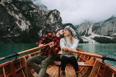 Braies, İtalya 'da bir dağ gölünü ziyaret eden genç ve güzel bir çift - sonbahar yaprakları arasında tatil yapan yürüyüş kıyafetli turistler - seyahat, yaşam tarzı ve seyahat tutkusu kavramları