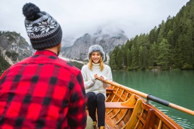 Braies, İtalya 'da bir dağ gölünü ziyaret eden genç ve güzel bir çift - sonbahar yaprakları arasında tatil yapan yürüyüş kıyafetli turistler - seyahat, yaşam tarzı ve seyahat tutkusu kavramları