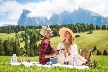 Beautiful young couple travelling in the Dolomites, Italy - Two lovers having a day trip in the nature clipart