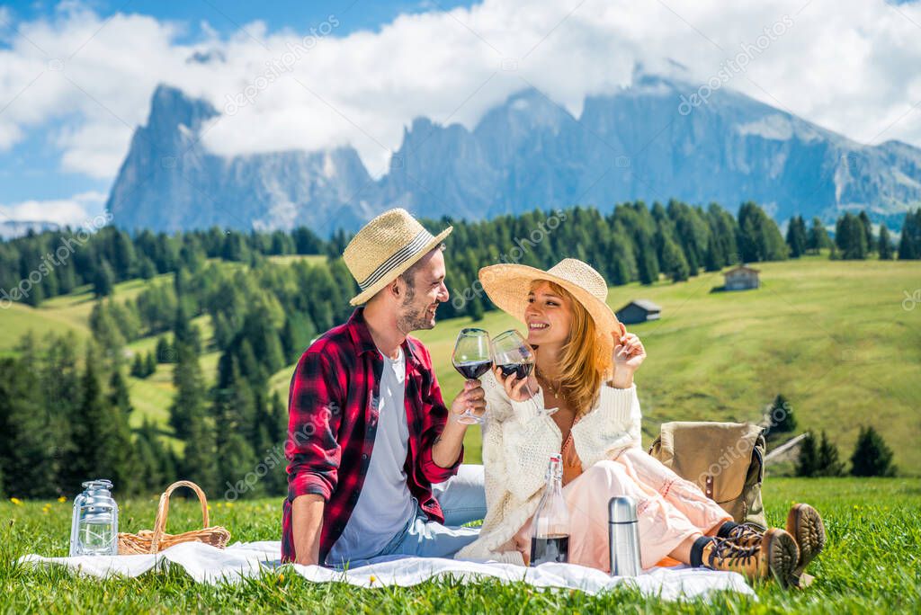 Beautiful young couple travelling in the Dolomites, Italy - Two lovers having a day trip in the nature
