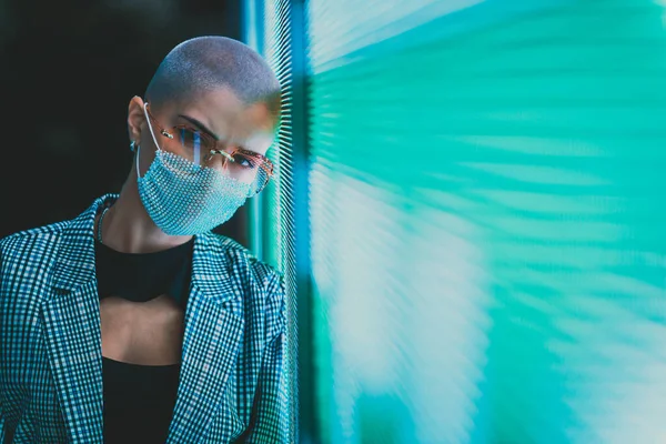 Image of a beautiful young woman posing against a led panel. teenager with alternative look and grey wig making urban portraits